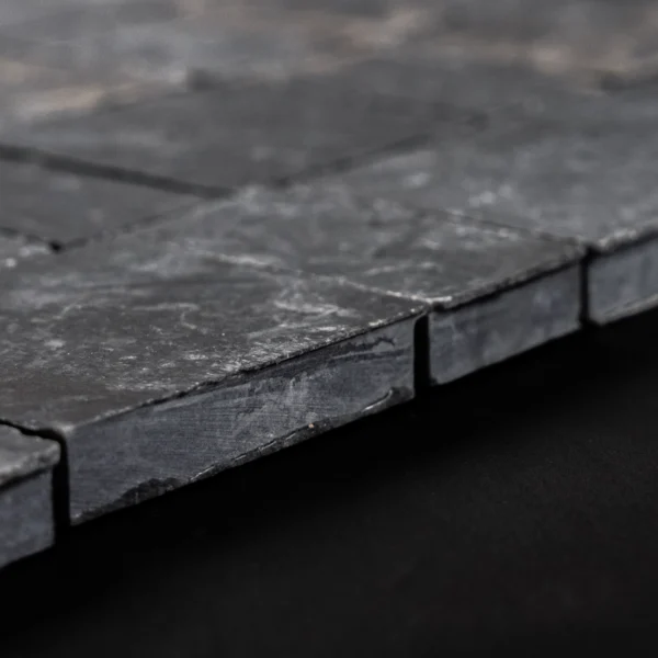Macro edge shot of the Pearl Black honed marble mosaic highlighting tile thickness, smooth honed face, and crisp square edges.