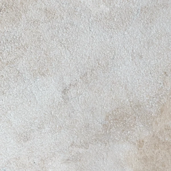 Close-up of 12x24 Royal Beige leathered marble paver showcasing its creamy beige background and lightly textured surface.