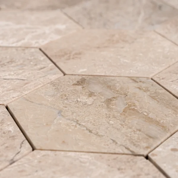 Close-up view of Royal Beige 4-inch honeycomb honed marble mosaic tiles, showing natural beige tones and soft matte texture.