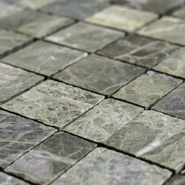 Close-up across the sheet highlighting mixed green shades and organic vein patterns on the square tiles.