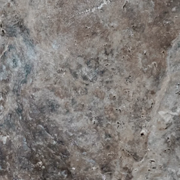 detailed view of the textured, tumbled surface with mottled grays and taupes, cloudy veining, and characteristic travertine pores.