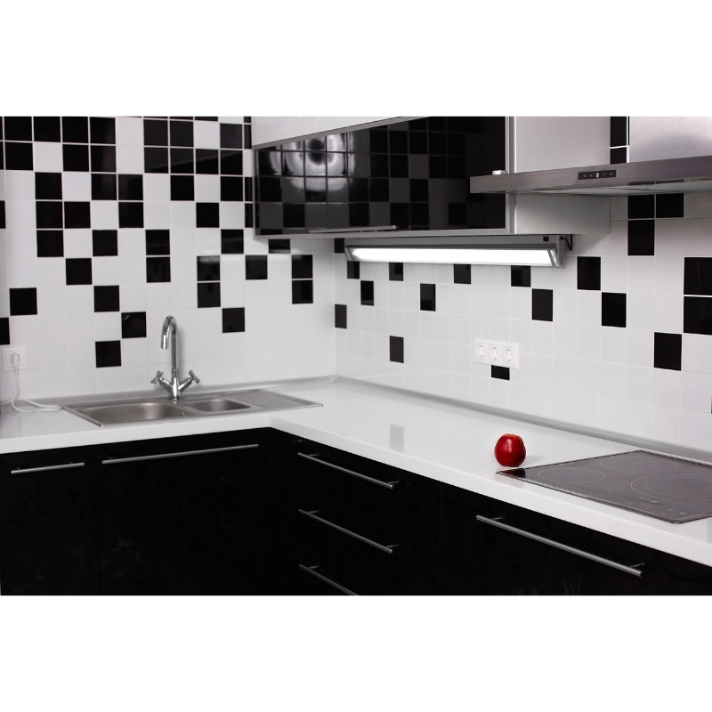 Black and white mosaic tile backsplash design creating bold contrast in modern kitchen interior
