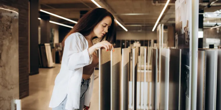 customer selecting marble and natural stone tile samples in modern showroom