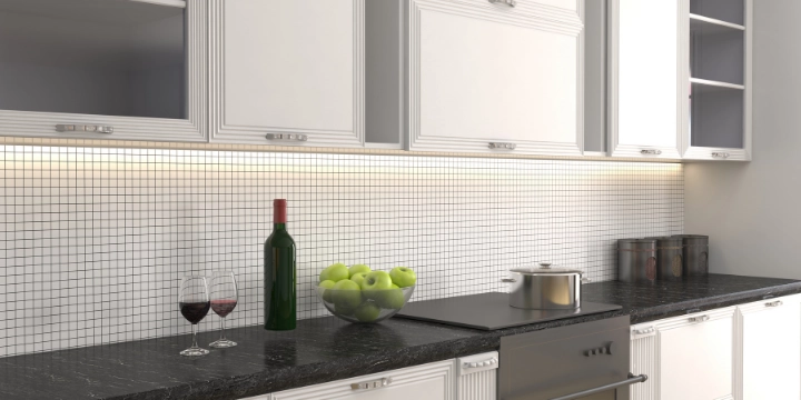 white mosaic tile kitchen backsplash with granite countertop