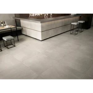 Close-up of Azuma CG 24x24 porcelain paver showing the natural surface texture and crisp rectified joints in an outdoor setting.