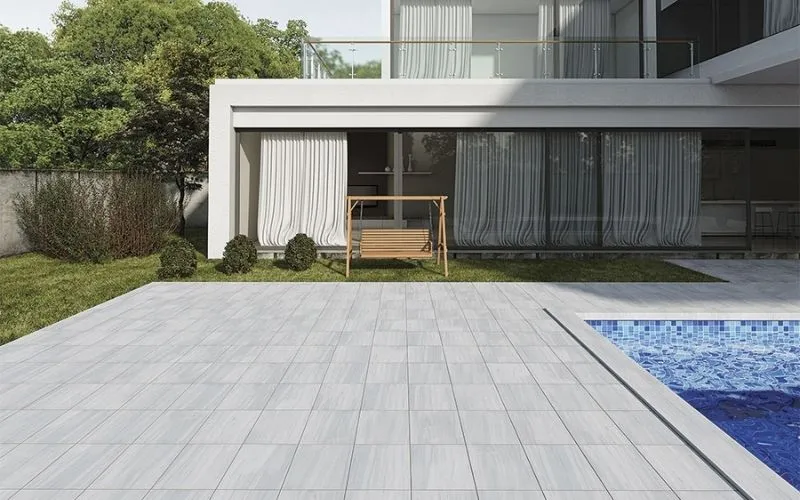 Leather finish marble pavers installed around a modern outdoor pool deck