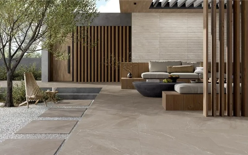 Sandblasted marble pavers installed on an outdoor patio with a textured natural stone finish