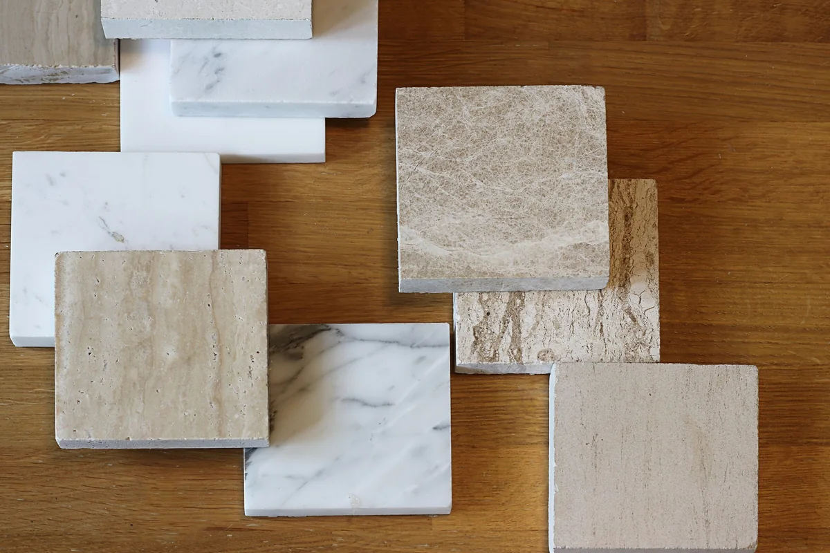 Top view of marble color samples on an oak wood table