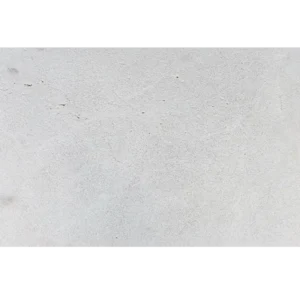 Close-up of Crema Bella 16x24 natural stone paver showing its light beige color and leather finish texture