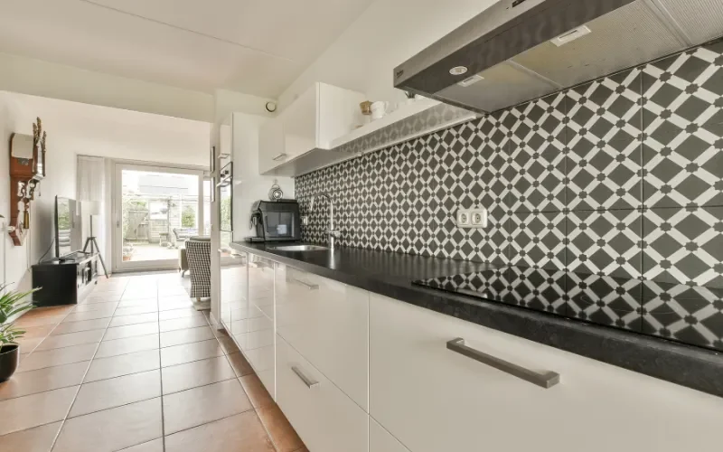 black and white patterned mosaic tile backsplash in modern kitchen