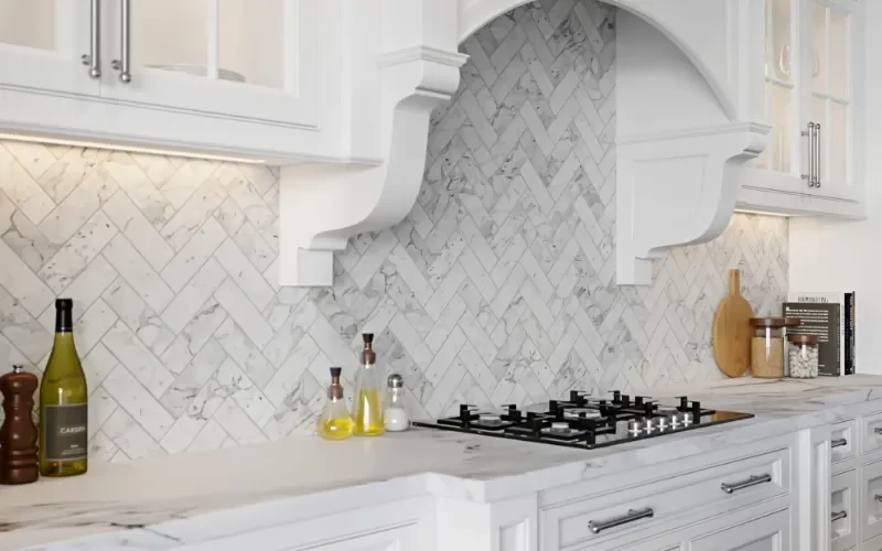 White marble herringbone mosaic tile kitchen backsplash in a luxury Fort Lauderdale coastal style kitchen